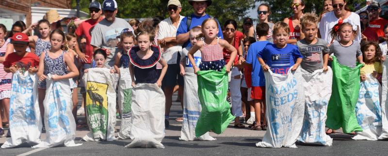 A line of sack racers fills the width of Second Street.